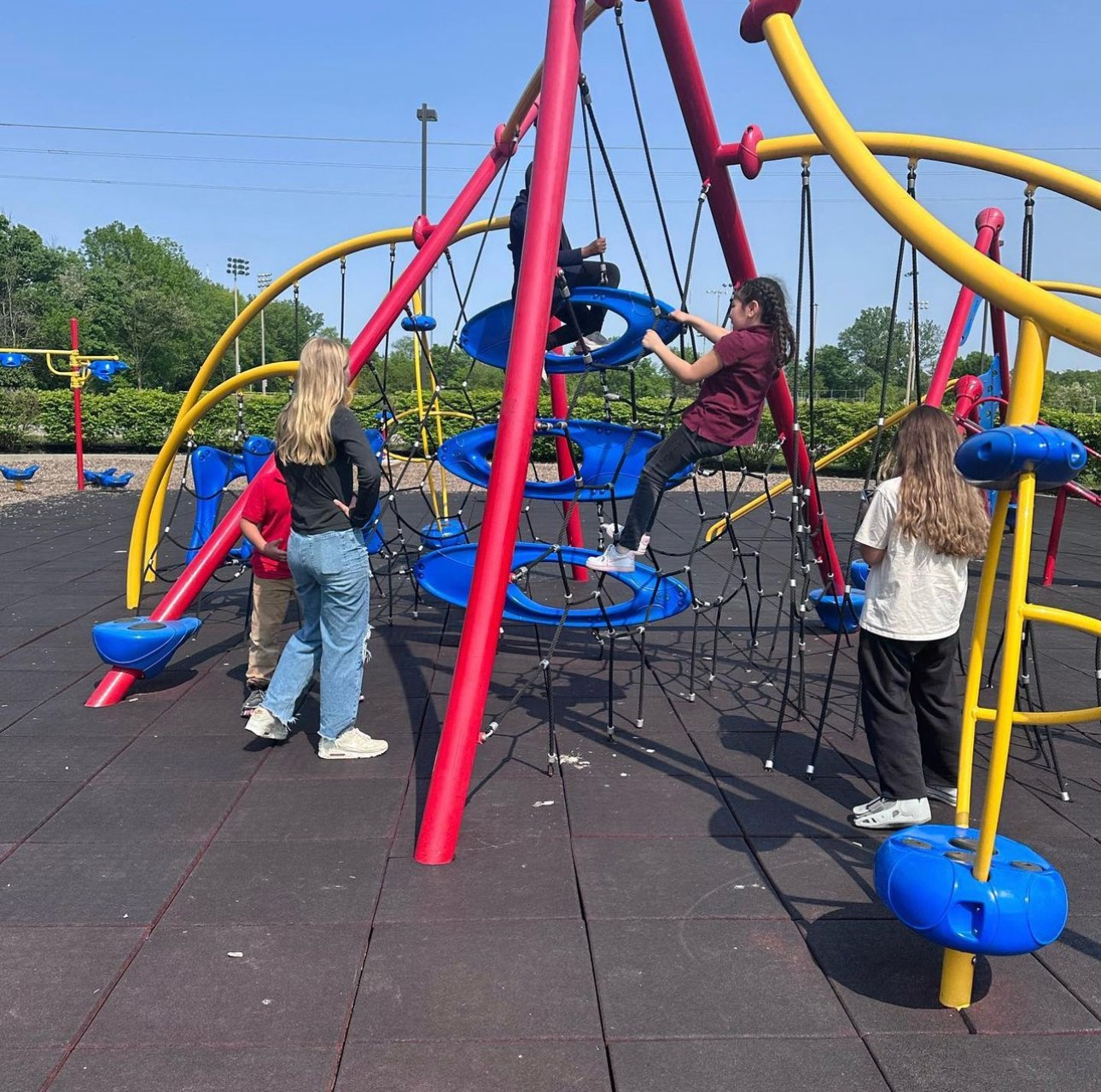 Students and tutors playing together on the playground at recess