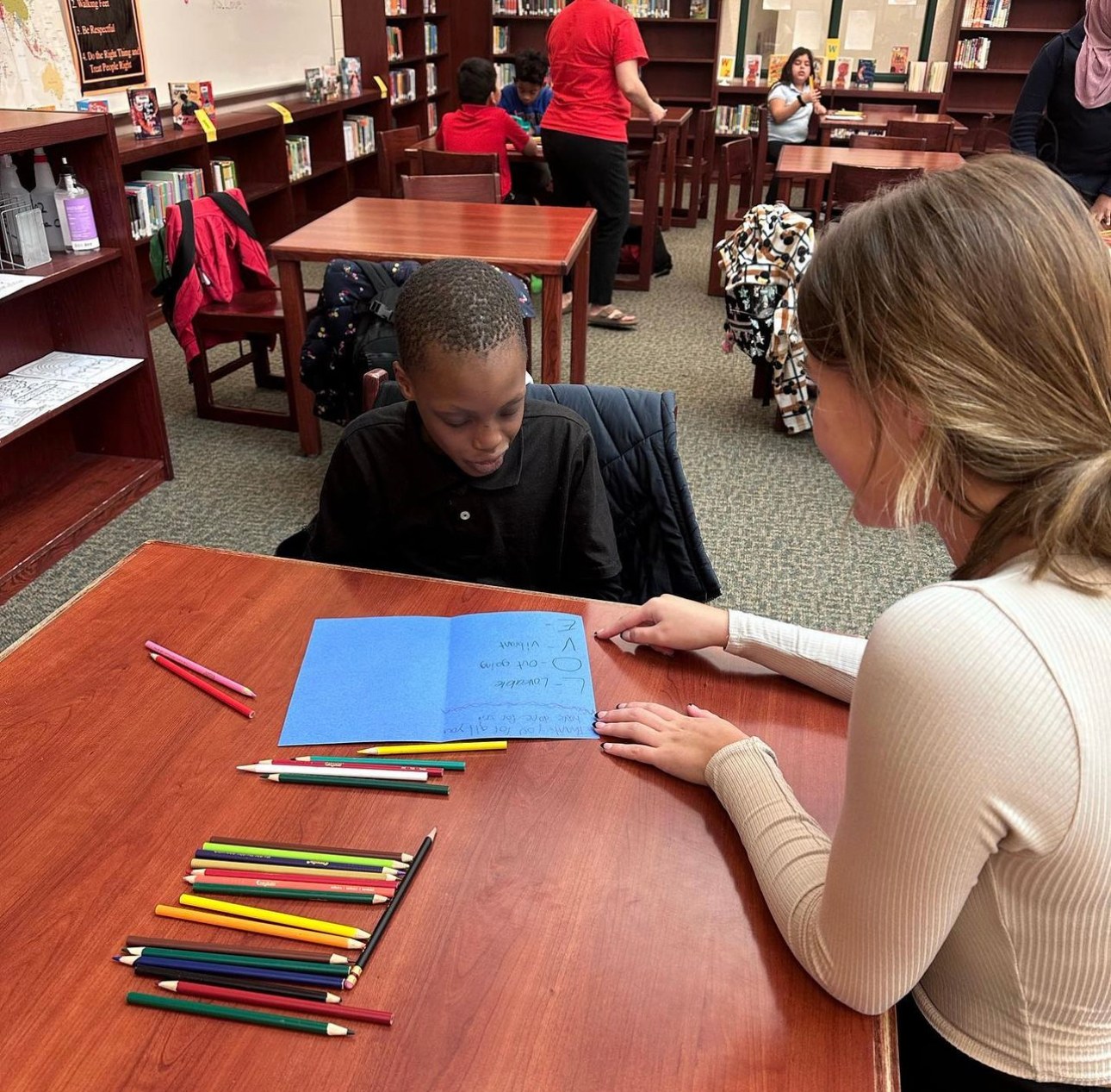 One-on-one tutoring at a library table